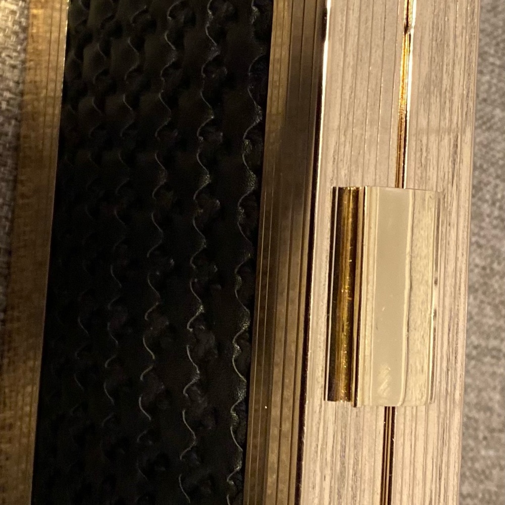 Black and gold clutch bag. It can goes with anything has a little gold chain